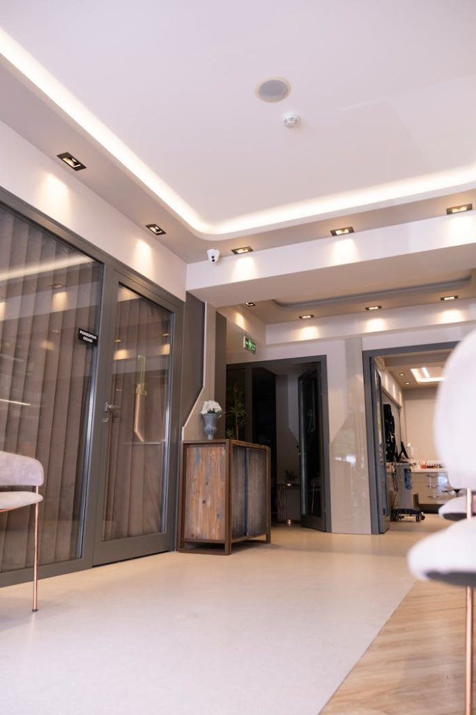 Spacious modern hotel lobby with sleek furniture and lighting featuring elegant interior design.